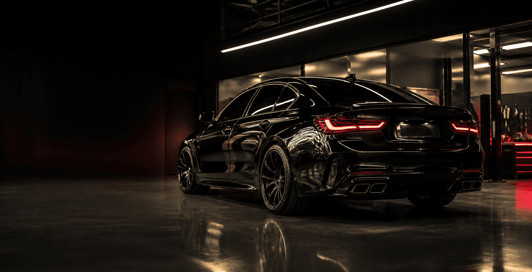 Vehículo negro premium dentro de un taller automotriz moderno